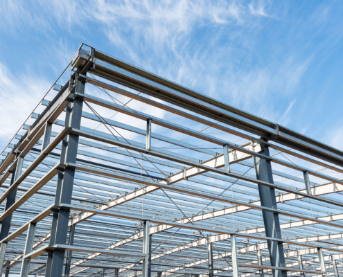 Side view of steel structure workshop with blue sky