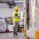 walking through warehouse with clipboard